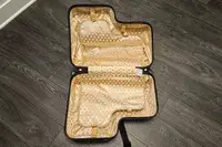 An opened and empty Younglingz Ride On Suitcase on a floor