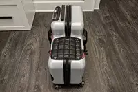 The back view of the Younglingz Ride On Suitcase on a wooden floor