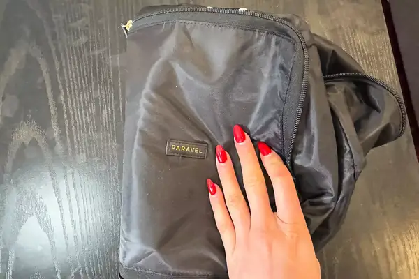 A hand holds a Paravel Fold-Up Bag