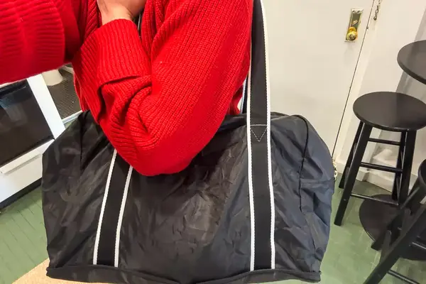 A person carries a Paravel Fold-Up Bag on their shoulder