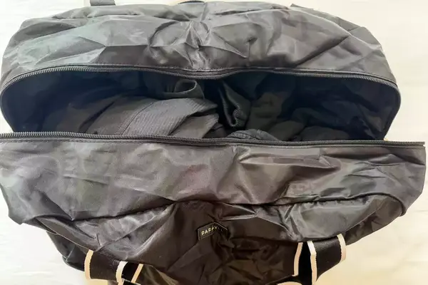 Top-down view of a Paravel Fold-Up Bag with clothing inside