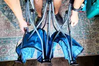 A person unfolds the Regalo My Cot Deluxe Portable Toddler Bed