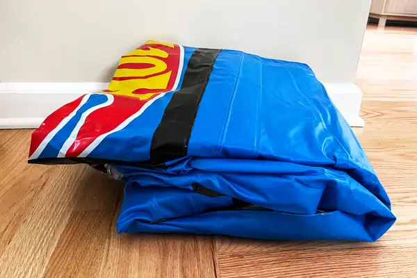 The Funboy Kids Sleepover Air Mattress folded up on a wooden floor