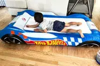 A child lays on the Funboy Kids Sleepover Air Mattress
