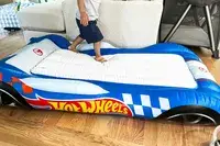 A child walks on top of the Funboy Kids Sleepover Air Mattress