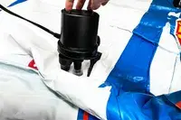 A person inflates the Funboy Kids Sleepover Air Mattress using an electric pump