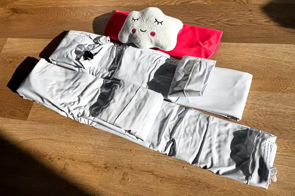 The Sleepah Inflatable Toddler Travel Bed folded up on a table