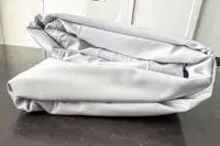 A side view of the folded Sleepah Inflatable Toddler Travel Bed