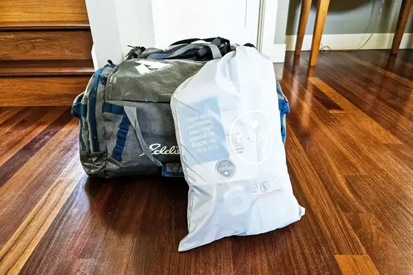 The Regalo Inflatable Toddler Bed inside a branded storage bag