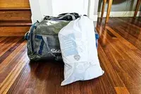 The Regalo Inflatable Toddler Bed inside a branded storage bag