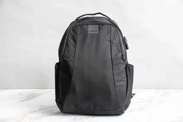 A person places a laptop into the Solo NY Stealth Hybrid Backpack