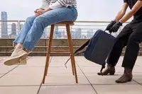 A person pulls on the XDDesign Bobby Bizz 3-in-1 Anti-Theft Backpack & Briefcase 