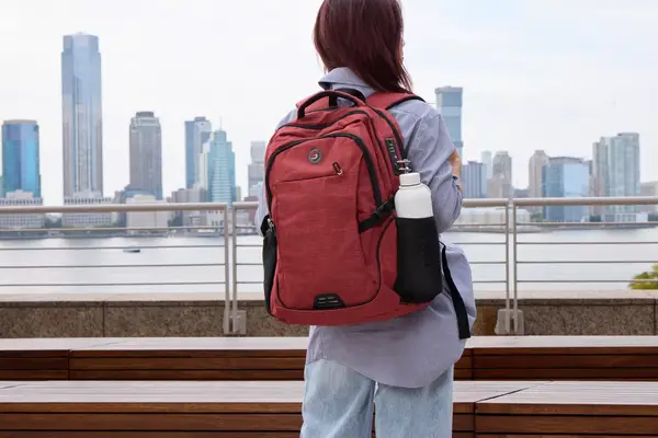 A person wears the SHRRADOO Anti Theft Laptop Backpack outside