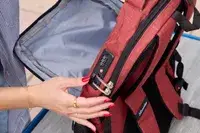 A person touches the lock on the SHRRADOO Anti Theft Laptop Backpack