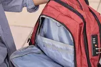 A person holds open the pocket on the SHRRADOO Anti Theft Laptop Backpack
