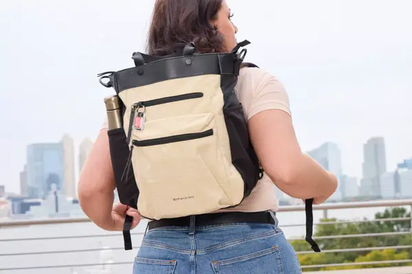 A person wears the Sherpani Soleil Convertible Travel Backpack on their back