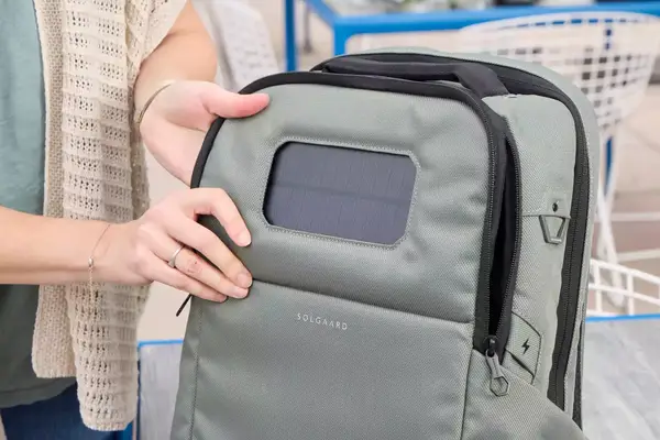 A person holds the front of the Solgaard Lifepack Backpack