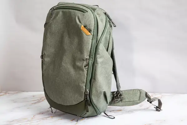 A person uses a box cutter to cut the Solo NY Stealth Hybrid Backpack fabric