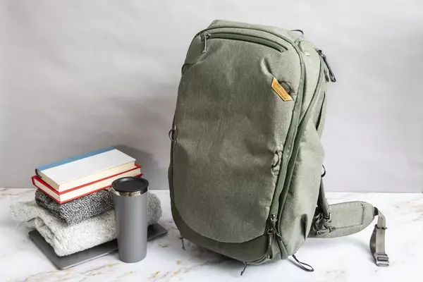A person places a water bottle into the Solo NY Stealth Hybrid Backpack