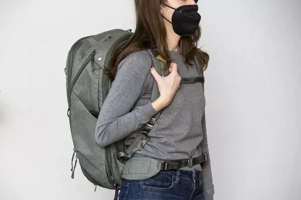 A person cuts the strap on the Solo NY Stealth Hybrid Backpack