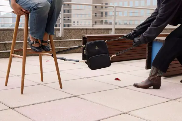 A person throws the Arden Cove Carmel Convertible Backpack and Crossbody on the ground