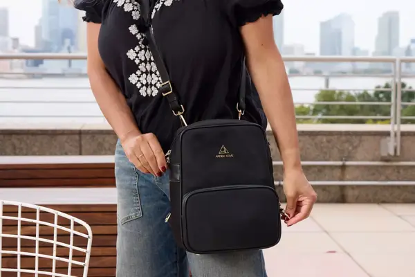 A person unzips the Arden Cove Carmel Convertible Backpack and Crossbody