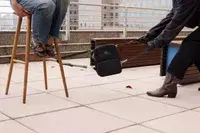 A person throws the Arden Cove Carmel Convertible Backpack and Crossbody on the ground