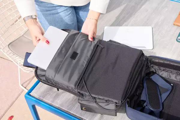 A person places a laptop inside the XDDesign Bobby Bizz 3-in-1 Anti-Theft Backpack & Briefcase