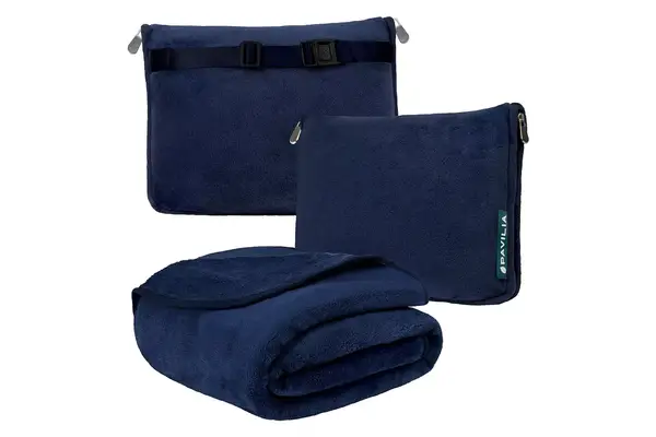 The Ostrich Pillow Go Neck Pillow resting on a suitcase