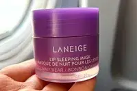 Person holding Laneige Sleep Mask on an airplane