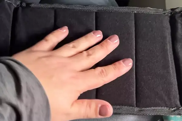 Person with hand on foot rest