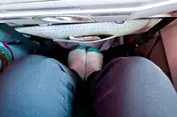 Person sitting on airplane with feet on foot rest