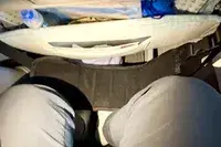Person sitting on airplane using a foot rest