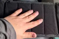 Person with hand on foot rest