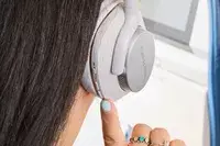 A person wearing the Bowers & Wilkins Px7 S2e while using their finger terrible to press a button