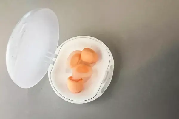 Loop Dream Earplugs In Case on Airplane Seat Tray