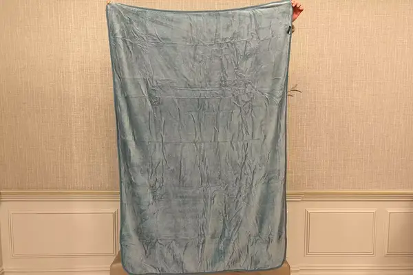 PAVILIA Travel Blanket being held up