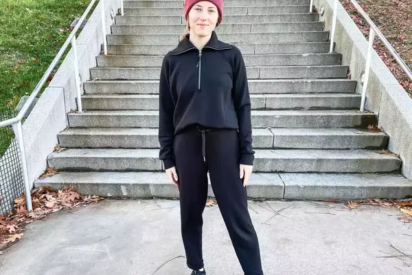 A person wearing the Spanx AirEssentials Tapered Pant outside