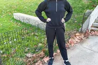 A person wearing the Spanx AirEssentials Tapered Pant outside 