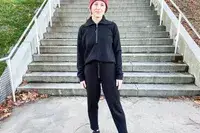 A person wearing the Spanx AirEssentials Tapered Pant outside