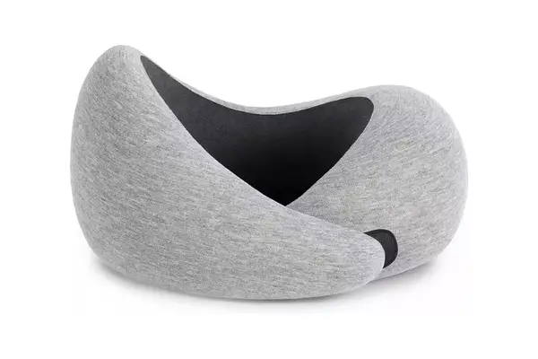 A person wearing the Lunya Washable Silk Sleep Mask on an airplane