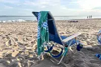 The Bay Laurel Turkish Beach Towel on a chair