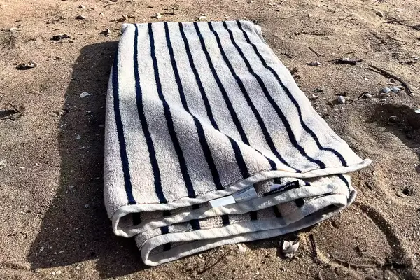 Brooklinen Super-plush Turkish Cotton Bath Towel on a beach