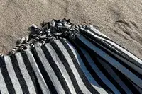 A close up of the Fairmont Turkish Linen Towel on a beach