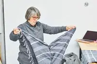 A person unfolding the Cacala 100% Organic Cotton Pestemal Turkish Bath Towel