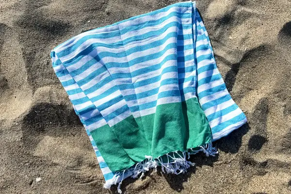 The Bay Laurel Turkish Beach Towel on sand