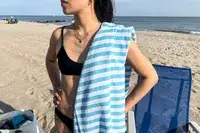 The Bay Laurel Turkish Beach Towel on a person