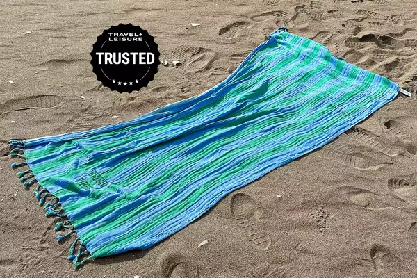 Mark and Graham cabana stripe lightweight reversible turkish towel on sand