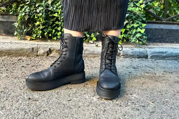 A person stands outside while wearing the Thursday Boot Co. Quest Boots