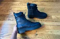 A person holds up the Thursday Boot Co. Quest Boot